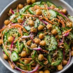 Asian cucumber and chickpea slaw with sesame dressing in a bowl.