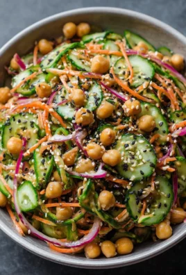 Asian cucumber and chickpea slaw with sesame dressing in a bowl.