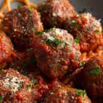 Savory baked Italian meatballs served with marinara sauce and spaghetti.