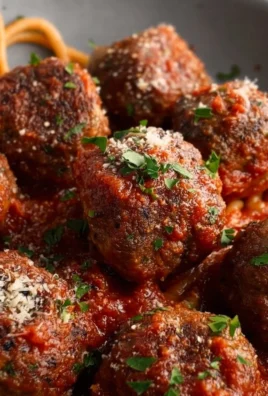 Savory baked Italian meatballs served with marinara sauce and spaghetti.