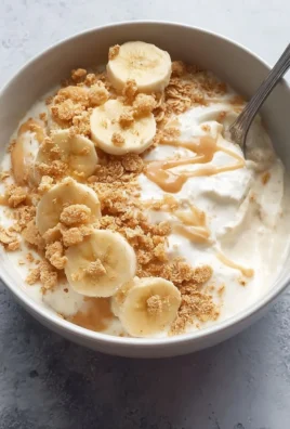 Delicious Banana Pudding Greek Yogurt Bowl topped with slices of banana.