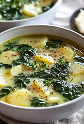 Bowl of creamy spinach potato soup garnished with fresh herbs