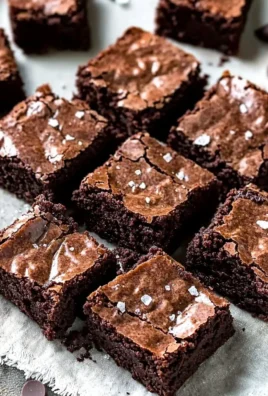 Delicious brown butter brownies on a plate with chocolate drizzle