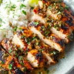 Plate of Cilantro Lime Chicken garnished with fresh cilantro and lime wedges.