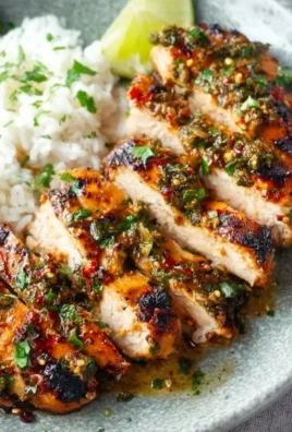 Plate of Cilantro Lime Chicken garnished with fresh cilantro and lime wedges.
