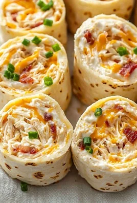 Crack Chicken Pinwheels served on a platter garnished with herbs