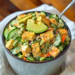 Creamy Asian cucumber salad with vibrant garnishes served in a bowl