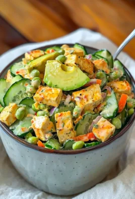 Creamy Asian cucumber salad with vibrant garnishes served in a bowl