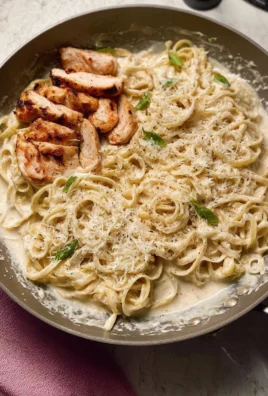 Creamy white sauce pasta dish with herbs and vegetables