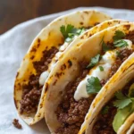 Delicious crispy ground beef tacos served with fresh toppings