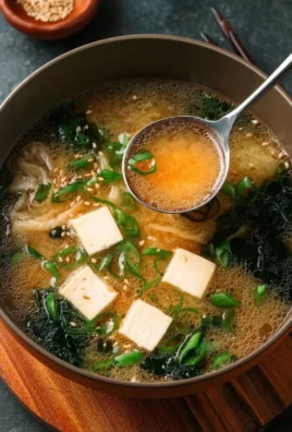 A bowl of easy gluten-free miso soup garnished with green onions and tofu
