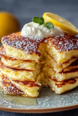 Fluffy lemon ricotta pancakes served with fresh berries and syrup