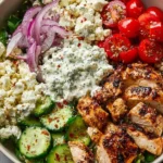 Delicious Greek chicken bowls with fresh vegetables and tzatziki sauce