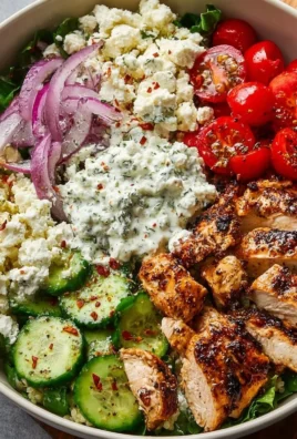 Delicious Greek chicken bowls with fresh vegetables and tzatziki sauce