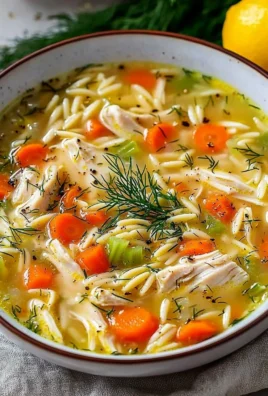 Bowl of Greek lemon chicken soup garnished with fresh herbs