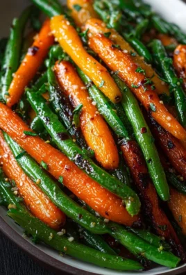 Honey glazed carrots and green beans served in a dish.
