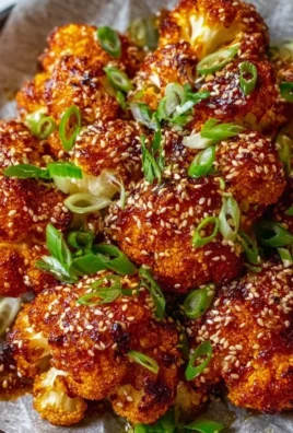 Korean Baked Cauliflower garnished with sesame seeds and green onions
