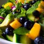 Mango Cucumber Salad with Blueberry and Avocado served in a bowl