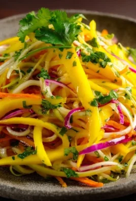 Colorful mango slaw with fresh vegetables in a bowl
