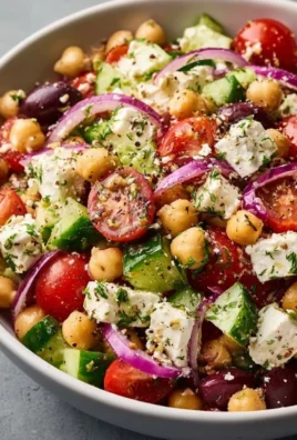 Mediterranean Chickpea Feta Salad with colorful vegetables and herbs