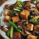 Delicious mushroom tofu stir-fry with colorful vegetables in a bowl