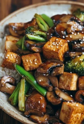 Delicious mushroom tofu stir-fry with colorful vegetables in a bowl