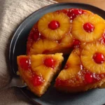 Delicious Pineapple Upside-Down Cake topped with caramelized pineapples and cherries.