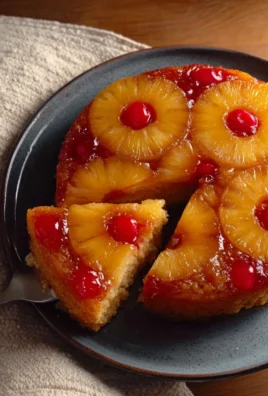 Delicious Pineapple Upside-Down Cake topped with caramelized pineapples and cherries.