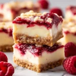 Decadent Raspberry Cheesecake Bars with a creamy layer and fresh raspberry topping