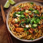Delicious sticky garlic chicken noodles served in a bowl