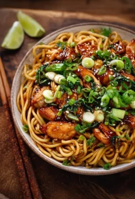 Delicious sticky garlic chicken noodles served in a bowl
