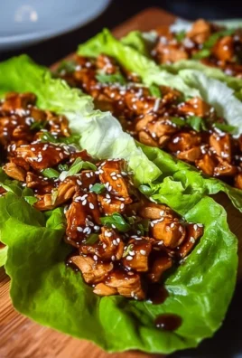 Delicious teriyaki chicken lettuce wraps served in a fresh green lettuce leaf.