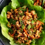 Thai chicken lettuce wraps served with fresh vegetables and herbs