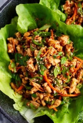 Thai chicken lettuce wraps served with fresh vegetables and herbs