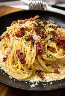 Plate of creamy spaghetti carbonara topped with grated cheese and parsley
