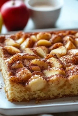 Delicious Apple Cinnamon Sheet Cake served on a wooden table.