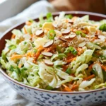 Colorful Asian Cabbage Salad topped with sesame dressing and fresh herbs