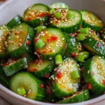 Bowl of Asian Spicy Cucumber Salad with vibrant vegetables and herbs