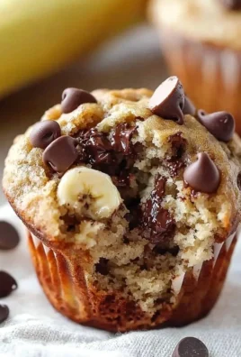 Freshly baked banana chocolate chip muffins on a cooling rack