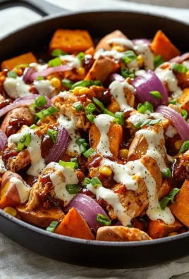 BBQ chicken sweet potato skillet in a cast iron pan with fresh herbs.