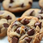 Biscoff chocolate chip cookies with a drizzle of melted chocolate on top.