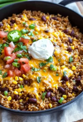 Cheesy taco rice skillet with toppings in a colorful dish.