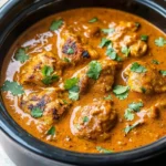 A delicious serving of homemade Crockpot Butter Chicken on a plate with rice.