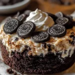 Easy Oreo Dump Cake topped with whipped cream and crushed Oreos