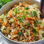 Egg roll in a bowl featuring vegetables and meat served in a bowl