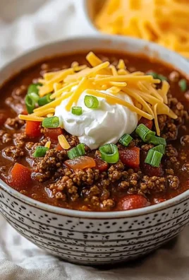 Ground Beef Chili without Beans in a bowl, topped with cheese and cilantro