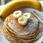 Fluffy high protein pancakes stacked with fresh berries and syrup