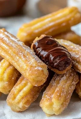 Plate of homemade churro bites drizzled with Nutella