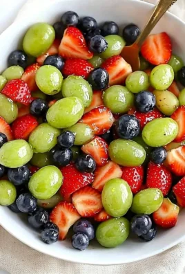 Bowl of colorful honey lime fruit salad with fresh fruits and lime dressing