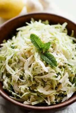 Bowl of colorful Lebanese Cabbage Slaw garnished with fresh herbs.